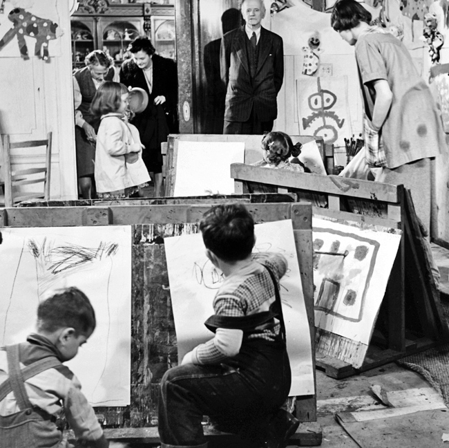 Group of Seven Arhur Lismer watching children paint at the Montreal Art Centre